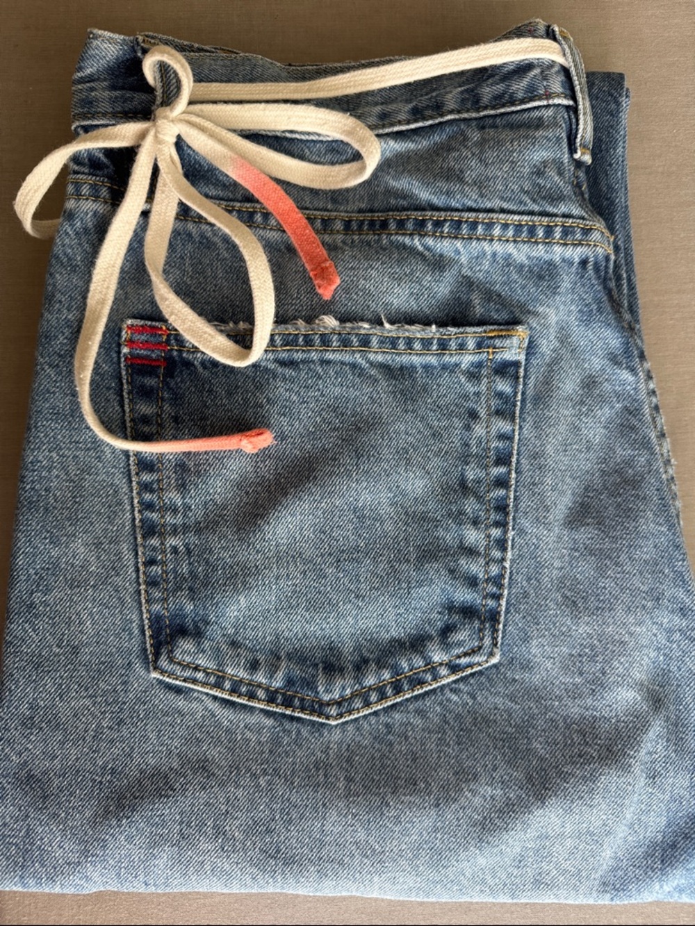 BDG Light Blue Boot Cut Jeans with Cream Drawstring and Pink-Tipped Ends